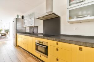 pretty-kitchen-with-yellow-kitchen-unit-and-hangin-2021-12-09-14-14-18-utc.jpg